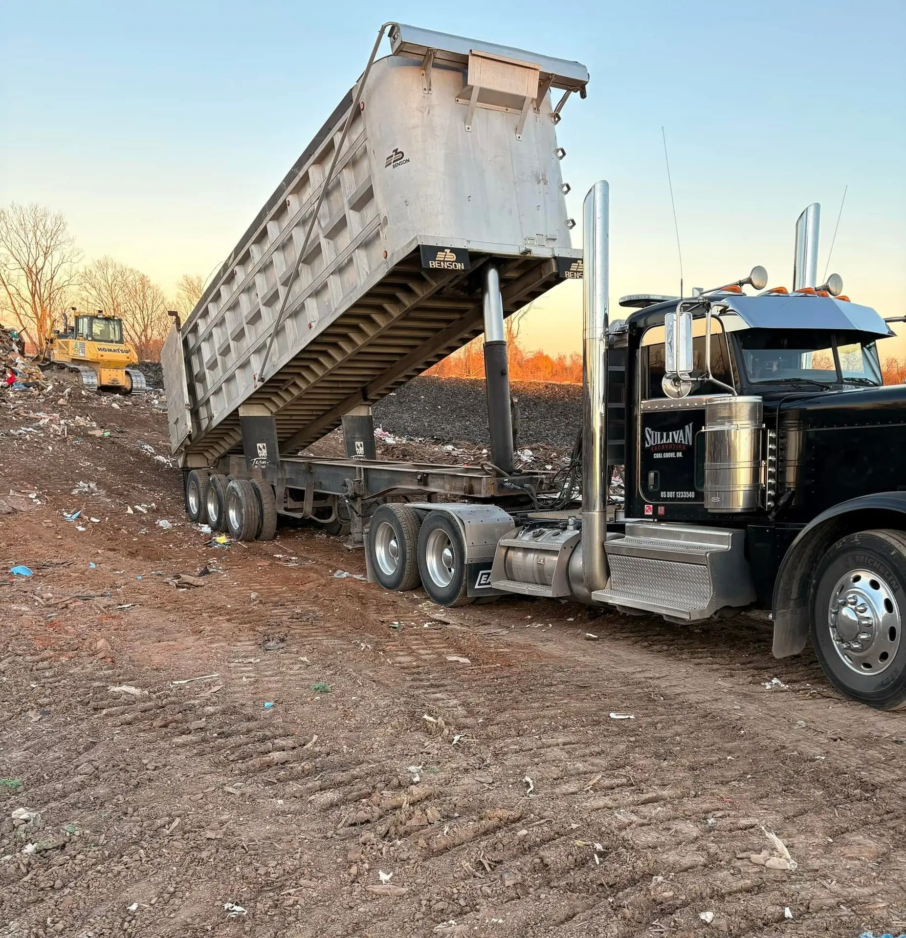 Mixed construction and demolition debris in a roll-off dumpster.