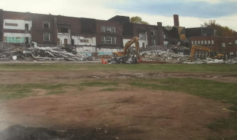 Selective demolition of a brick school building.